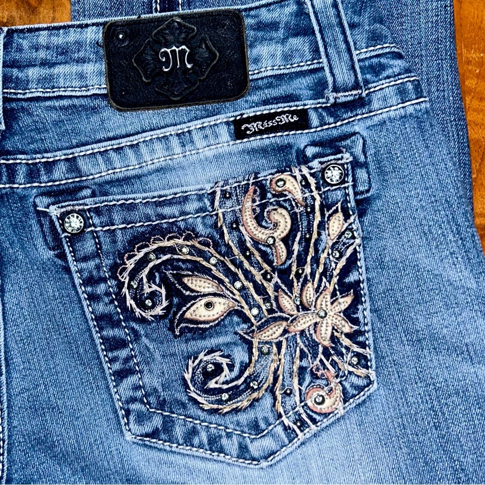 Embellished blue Y2K bootcut Miss Me jeans with embroidery and gems